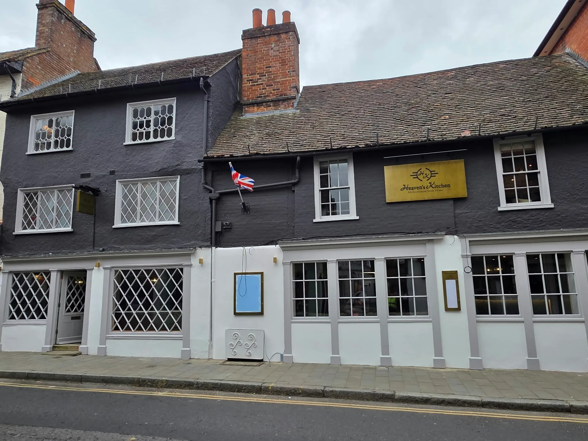 Black-painted timber-framed restaurant frontage on the high street