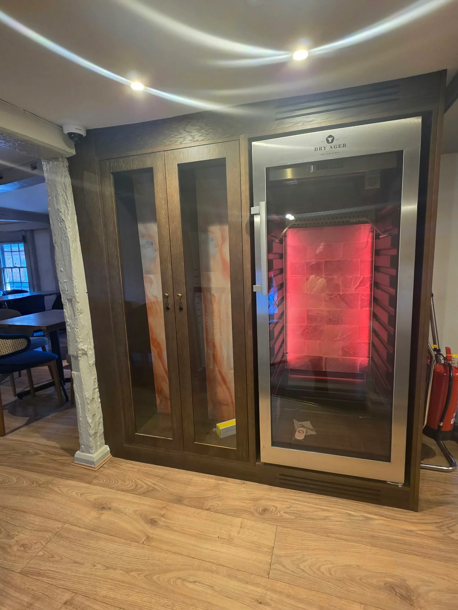 Dry-ageing meat cabinet built into dark joinery