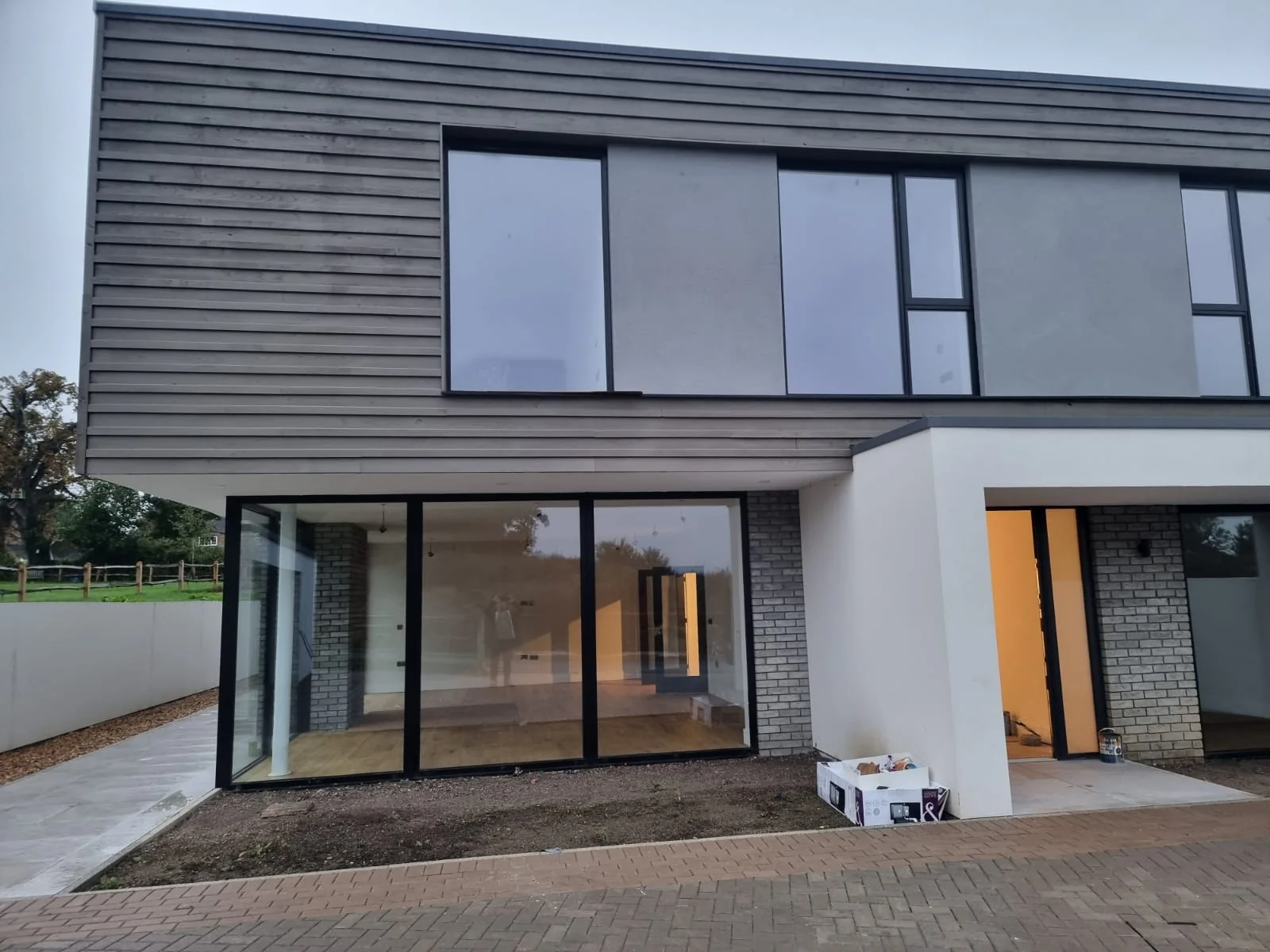 Rear elevation with full-height sliding doors and brick detailing