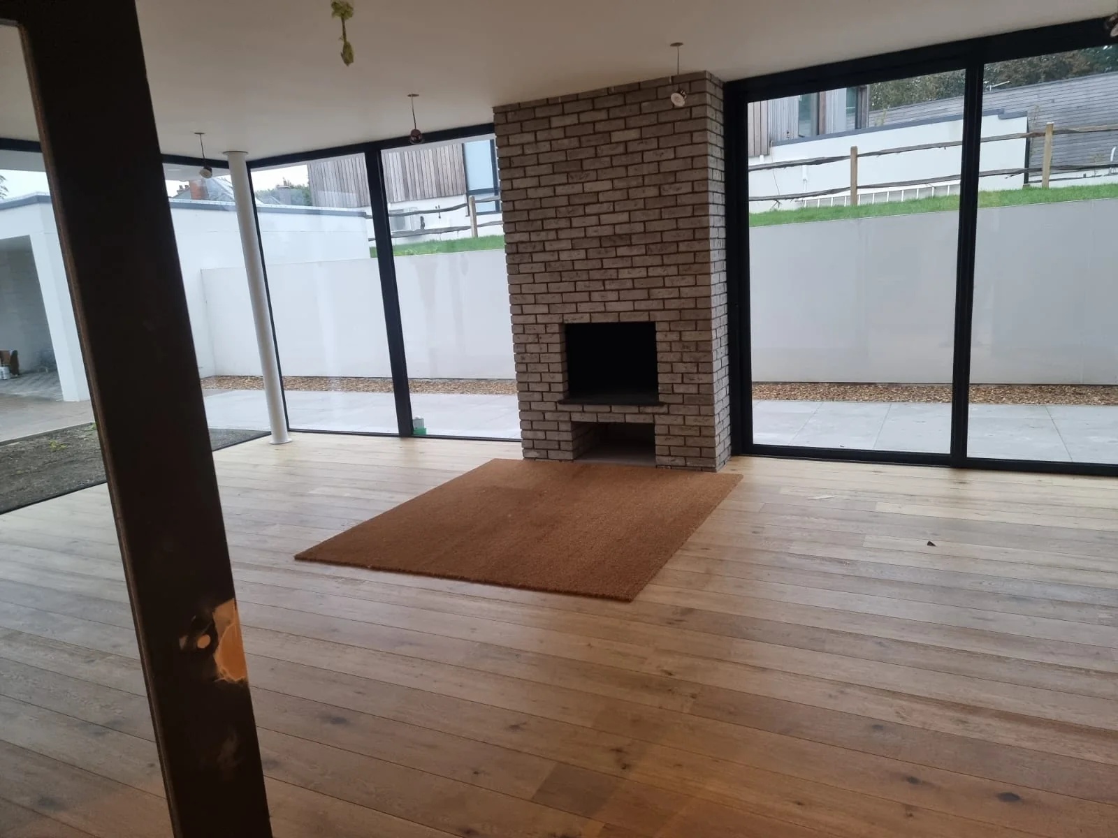 Living space with an oak floor and a brick fireplace
