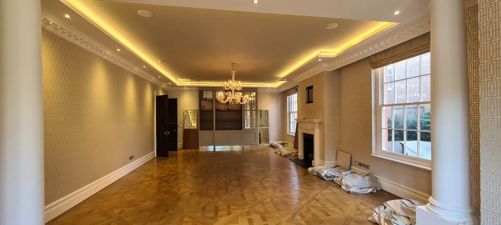 Reception room with parquet floor, columns and cove lighting