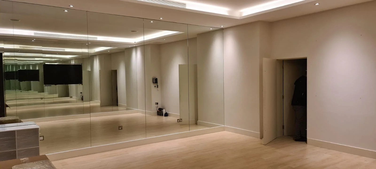 Home gym with a full-height mirrored wall