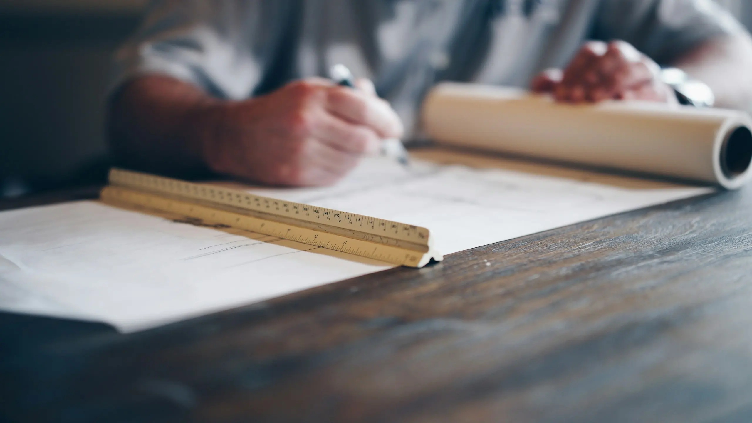 Hand drafting architectural plans with a pencil and scale rule (stock image)