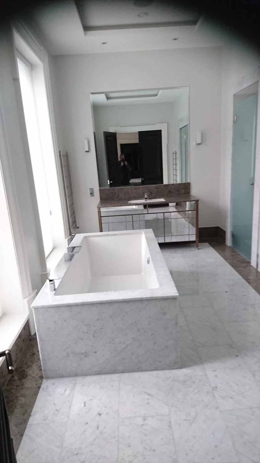 Marble bathroom with a built-in bath and vanity unit